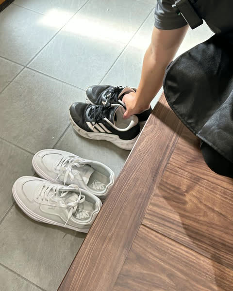 玄関で脱いだ靴をそろえるスタッフの手元